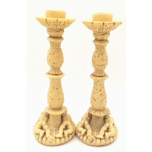 779 - A Pair of Antique Ivorine Candlesticks with Ornate Cherub Decoration. 22cm tall.