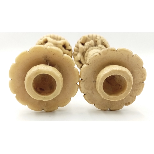 779 - A Pair of Antique Ivorine Candlesticks with Ornate Cherub Decoration. 22cm tall.