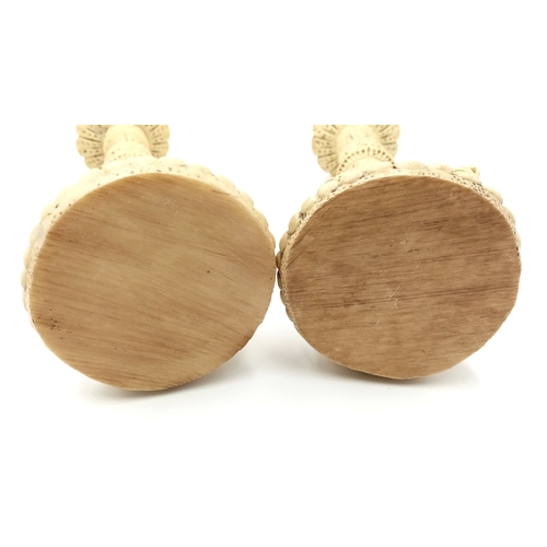 779 - A Pair of Antique Ivorine Candlesticks with Ornate Cherub Decoration. 22cm tall.