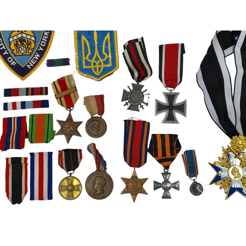 813 - A Huge Collection of Reproduction Military Metal and Textile  Badges. These were used by an amateur ... 