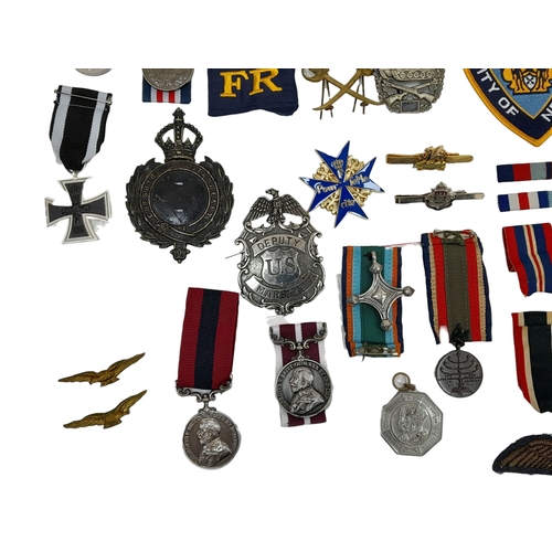 813 - A Huge Collection of Reproduction Military Metal and Textile  Badges. These were used by an amateur ... 