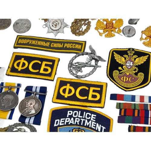 813 - A Huge Collection of Reproduction Military Metal and Textile  Badges. These were used by an amateur ... 