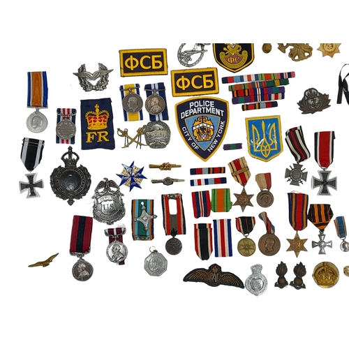 813 - A Huge Collection of Reproduction Military Metal and Textile  Badges. These were used by an amateur ... 