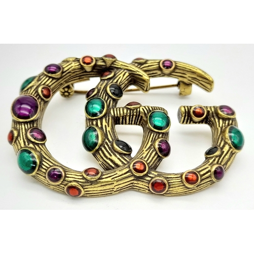 878 - A vintage Gucci stone set dress brooch. 5 X 4 cm.