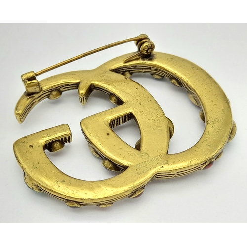 878 - A vintage Gucci stone set dress brooch. 5 X 4 cm.