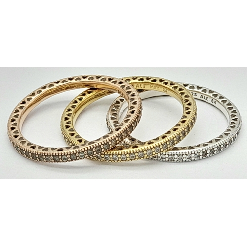 906 - A collection of 3 Pandora tri color gilded silver stone set rings. Total weight 6.7G. Sizes: 2 V and... 