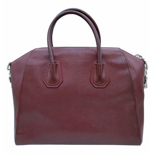 994 - A Givenchy Medium Antigona Tote Bag. Burgundy grained leather exterior with silver-toned hardware, t... 