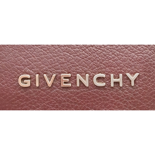 994 - A Givenchy Medium Antigona Tote Bag. Burgundy grained leather exterior with silver-toned hardware, t... 