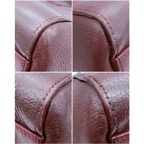 994 - A Givenchy Medium Antigona Tote Bag. Burgundy grained leather exterior with silver-toned hardware, t... 