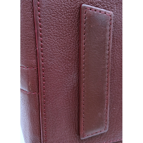 994 - A Givenchy Medium Antigona Tote Bag. Burgundy grained leather exterior with silver-toned hardware, t... 