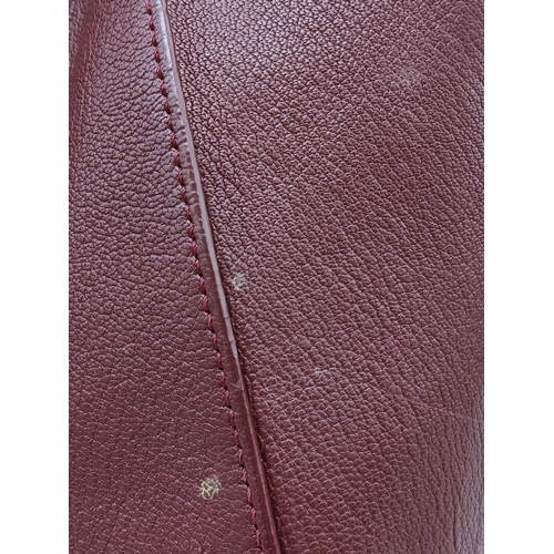 994 - A Givenchy Medium Antigona Tote Bag. Burgundy grained leather exterior with silver-toned hardware, t... 