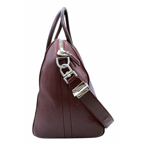 994 - A Givenchy Medium Antigona Tote Bag. Burgundy grained leather exterior with silver-toned hardware, t... 