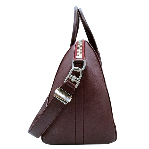 994 - A Givenchy Medium Antigona Tote Bag. Burgundy grained leather exterior with silver-toned hardware, t... 