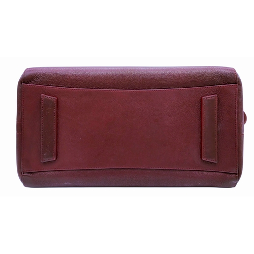 994 - A Givenchy Medium Antigona Tote Bag. Burgundy grained leather exterior with silver-toned hardware, t... 