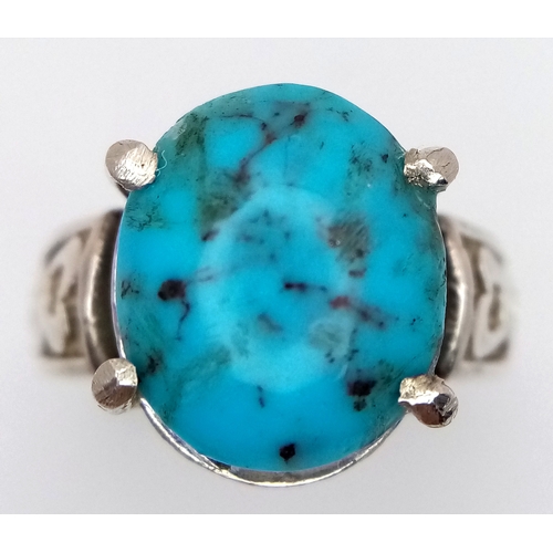 912 - A 925 silver Turquoise ring with further ornate decoration on the shoulders. Total weight 5.3G. Size... 