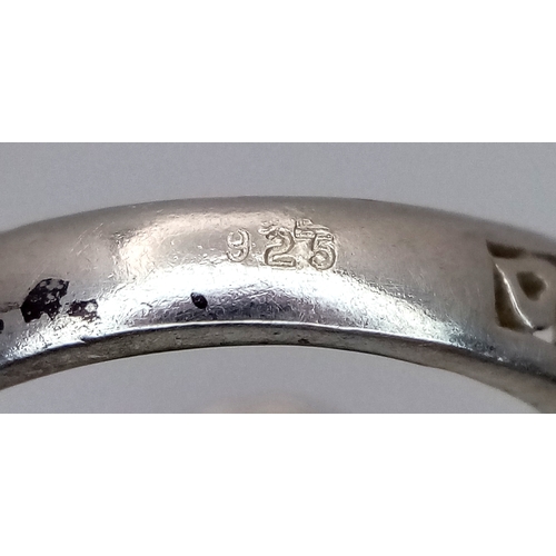 912 - A 925 silver Turquoise ring with further ornate decoration on the shoulders. Total weight 5.3G. Size... 