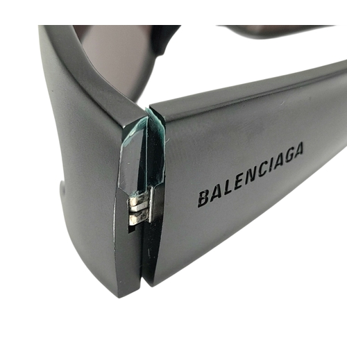 776 - A pair of Balenciaga black aluminium women's sunglasses. Total length 17cm. Comes with original case... 
