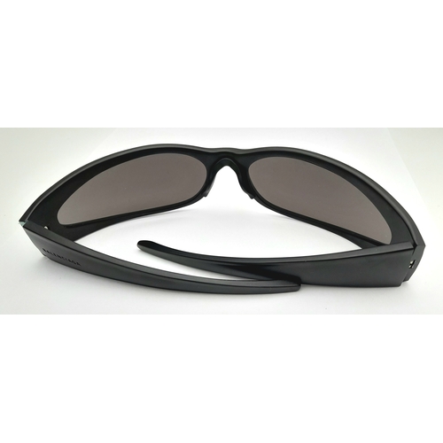 776 - A pair of Balenciaga black aluminium women's sunglasses. Total length 17cm. Comes with original case... 