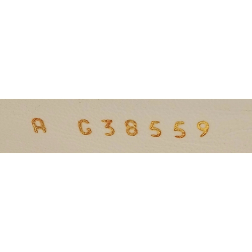 594 - A pair of Chanel White Patent Leather Chain Loafers. Gold-tone CC charm and chain detail across the ... 