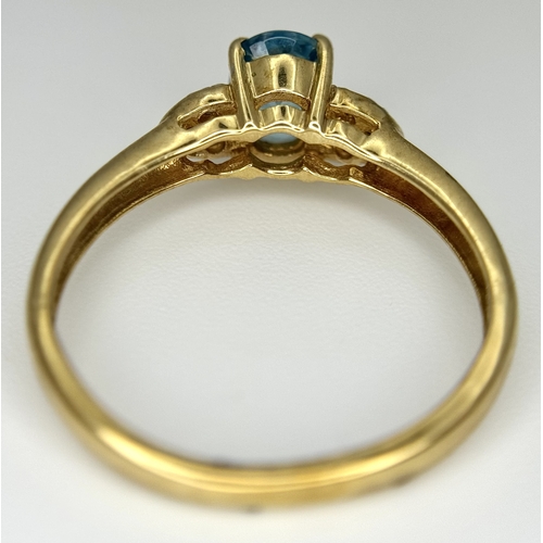 643 - A 9K Yellow Gold Blue Zircon and White Topaz Ring. 0.957ct Cambodian oval cut centre stone with 0.06... 