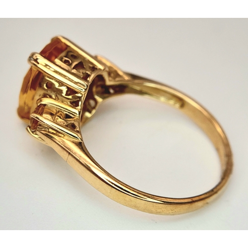 650 - A 9K Yellow Gold Citrine Ring. 2.316ct Antique cut centre stone with small round cut citrine accents... 
