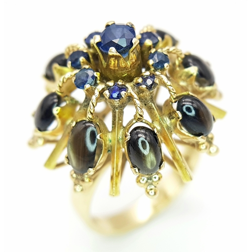 553 - A 14K Yellow Gold Sapphire Burst Ring. Eight black star oval sapphires in surround form of eight sma... 