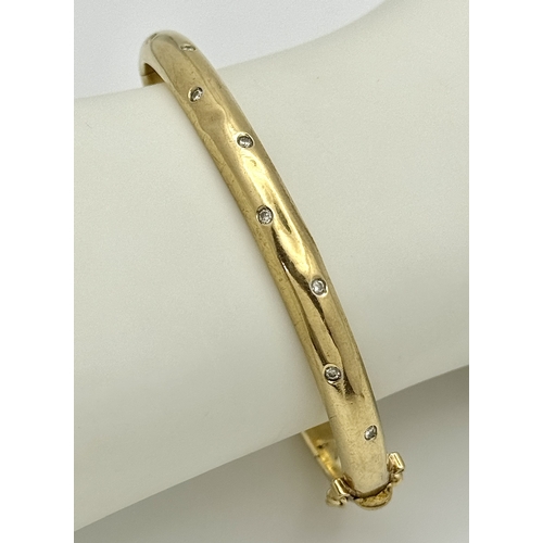 581 - A Vintage 9K Yellow Gold Diamond Set Bangle. A small kink mid bangle so as found. Clip open design. ... 