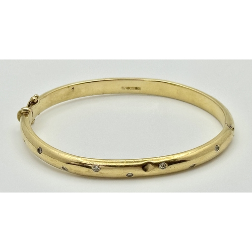 581 - A Vintage 9K Yellow Gold Diamond Set Bangle. A small kink mid bangle so as found. Clip open design. ... 
