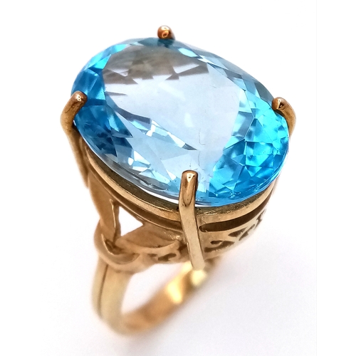 574 - A 9K Yellow Gold Blue Topaz Ring. Size N, 8.4g total weight.