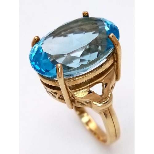 574 - A 9K Yellow Gold Blue Topaz Ring. Size N, 8.4g total weight.