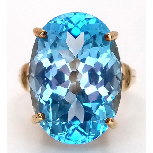 574 - A 9K Yellow Gold Blue Topaz Ring. Size N, 8.4g total weight.
