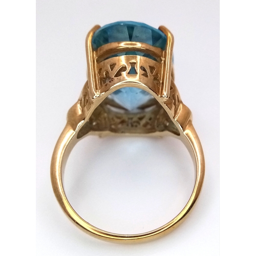 574 - A 9K Yellow Gold Blue Topaz Ring. Size N, 8.4g total weight.