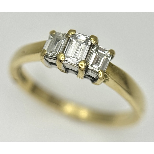 560 - An 18K Yellow Gold Emerald Cut Diamond Trilogy Ring. c. 0.50ctw. Size O. 3.45g. Ref: 18/82205.