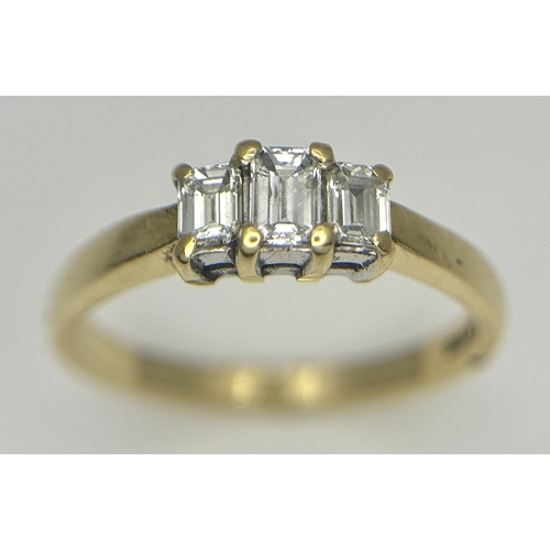560 - An 18K Yellow Gold Emerald Cut Diamond Trilogy Ring. c. 0.50ctw. Size O. 3.45g. Ref: 18/82205.