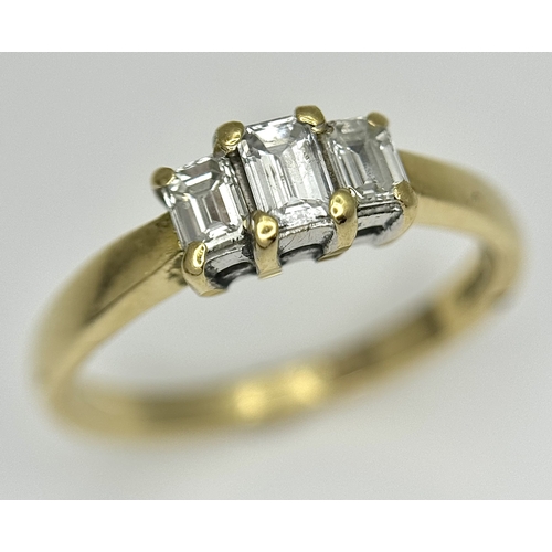 560 - An 18K Yellow Gold Emerald Cut Diamond Trilogy Ring. c. 0.50ctw. Size O. 3.45g. Ref: 18/82205.
