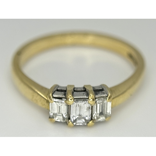 560 - An 18K Yellow Gold Emerald Cut Diamond Trilogy Ring. c. 0.50ctw. Size O. 3.45g. Ref: 18/82205.