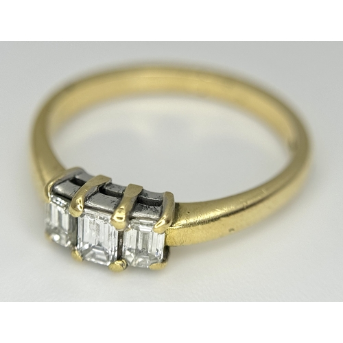 560 - An 18K Yellow Gold Emerald Cut Diamond Trilogy Ring. c. 0.50ctw. Size O. 3.45g. Ref: 18/82205.