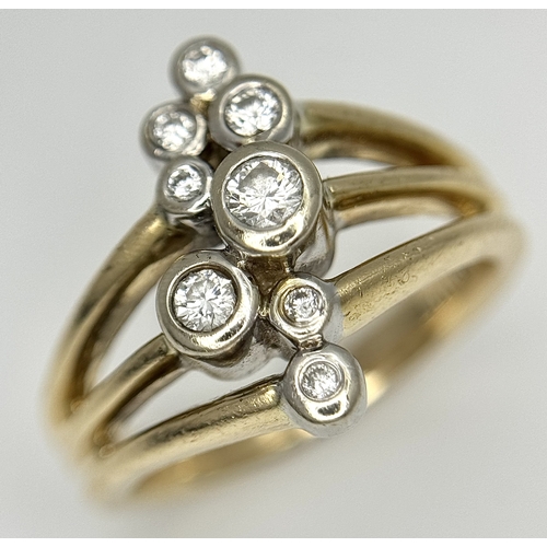 567 - A 14K Yellow Gold, Diamond Starburst Orbital Ring. c. 0.60ctw round brilliant cut diamonds. Size N. ... 