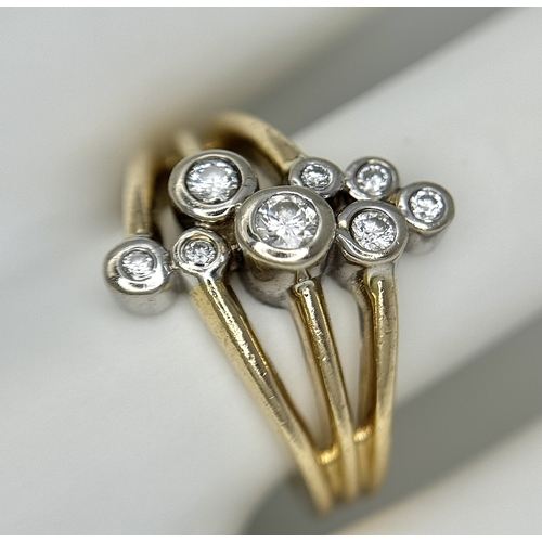 567 - A 14K Yellow Gold, Diamond Starburst Orbital Ring. c. 0.60ctw round brilliant cut diamonds. Size N. ... 