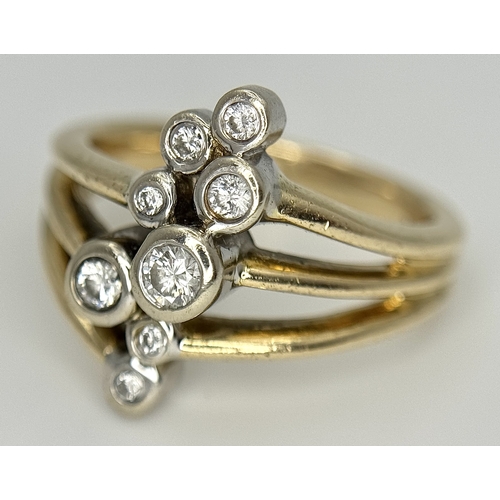 567 - A 14K Yellow Gold, Diamond Starburst Orbital Ring. c. 0.60ctw round brilliant cut diamonds. Size N. ... 