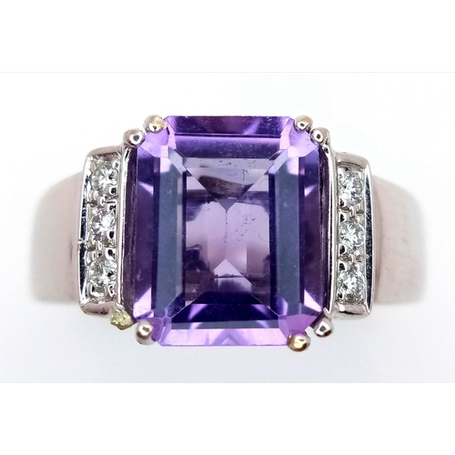 615 - An 18K White Gold (tested) Amethyst and Diamond Ring. A 2.5ct step cut amethyst with a three round b... 