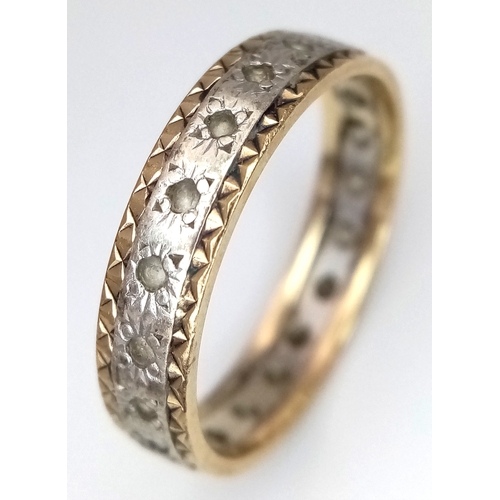 772 - A 9K Yellow and White Gold, White Stone Eternity Ring. Size N. 2.25g.