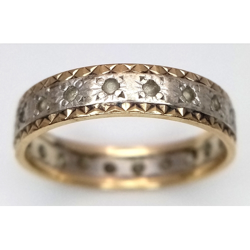 772 - A 9K Yellow and White Gold, White Stone Eternity Ring. Size N. 2.25g.