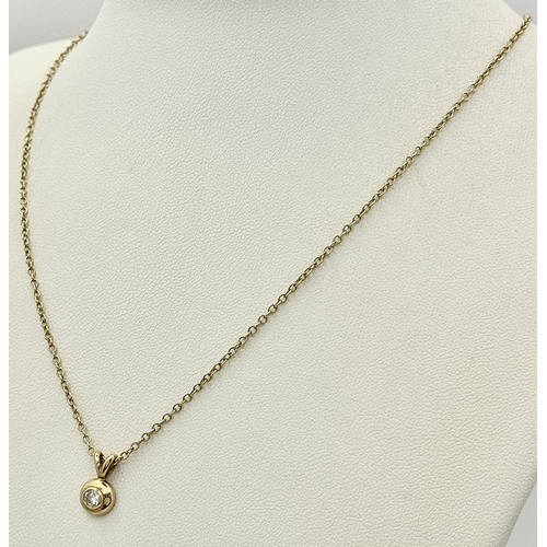 825 - A 9K Yellow Gold Diamond Pendant on a 9K Yellow Gold Chain. 1cm and 40cm. 2.5g. NL-27/61505.