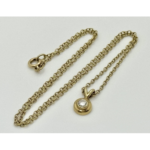 825 - A 9K Yellow Gold Diamond Pendant on a 9K Yellow Gold Chain. 1cm and 40cm. 2.5g. NL-27/61505.