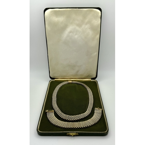 181 - A Glamourous Vintage 9K Yellow Gold Necklace and Bracelet Set. Intricate curved links create a stunn... 
