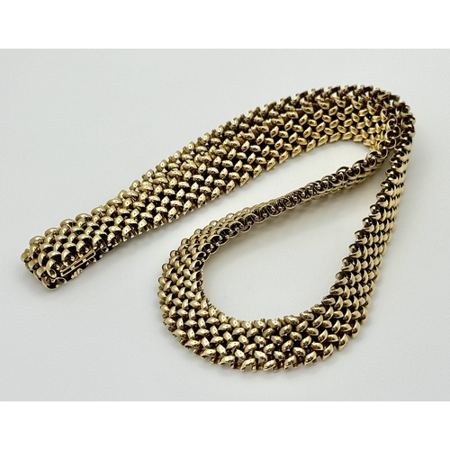 181 - A Glamourous Vintage 9K Yellow Gold Necklace and Bracelet Set. Intricate curved links create a stunn... 