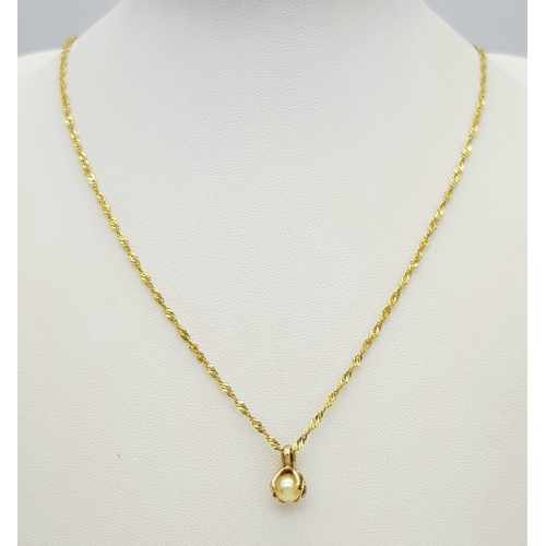 605 - A 50cms TWIST NECK CHAIN IN 14K GOLD WITH A PEARL PENDANT. 4.0gms