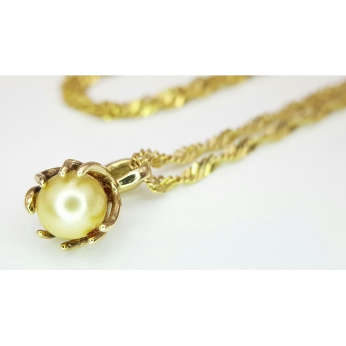 605 - A 50cms TWIST NECK CHAIN IN 14K GOLD WITH A PEARL PENDANT. 4.0gms
