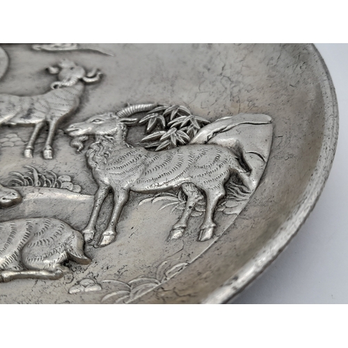 828 - A SUPERB VINTAGE/ANTIQUE CHINESE  WHITE METAL DISH DEPICTING  GOATS TO THE FRONT AND DRAGONS ON THE ... 